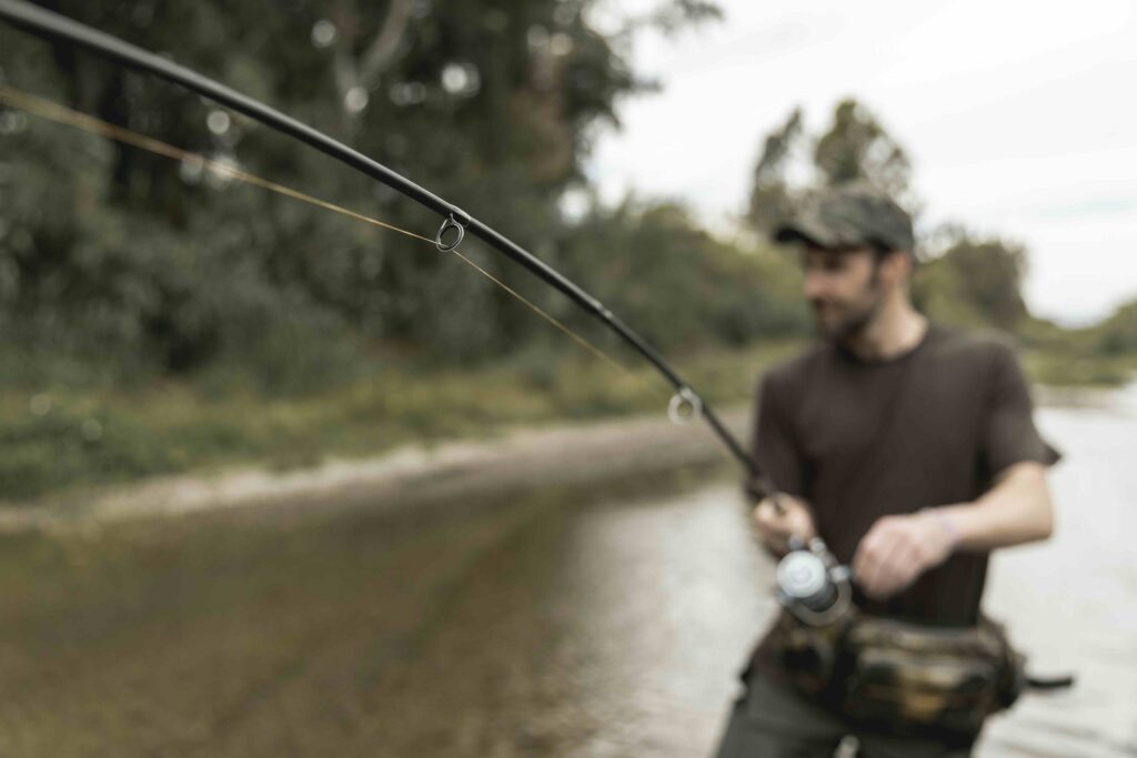 man fishing river