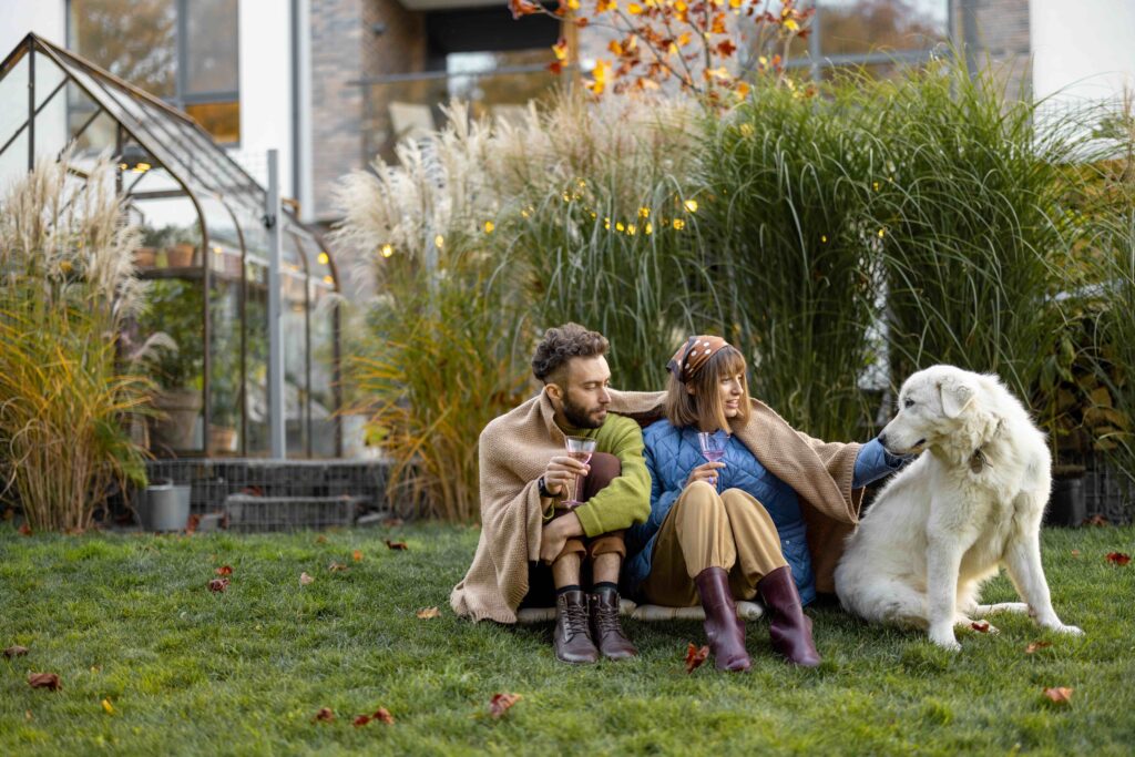 young couple with dog backyard