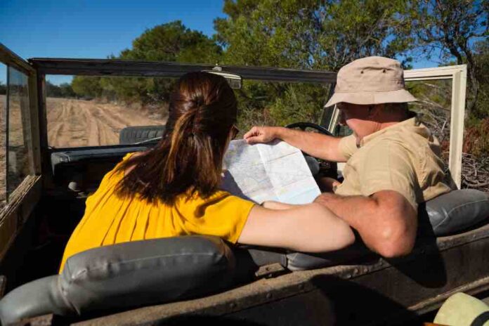 Hunter driving jeep and looking on map