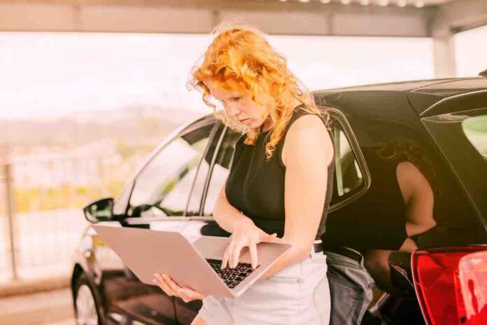 Women Standing outside carrying laptop